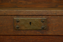 Hand hammered copper key escutcheon with pyramidal screws.